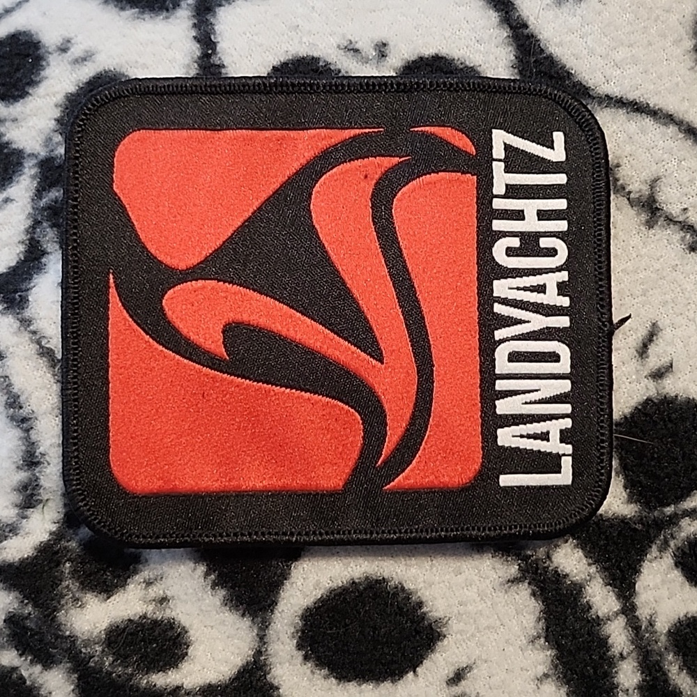 2 inch by 2.5 inch red Landyachtz sew-on patch